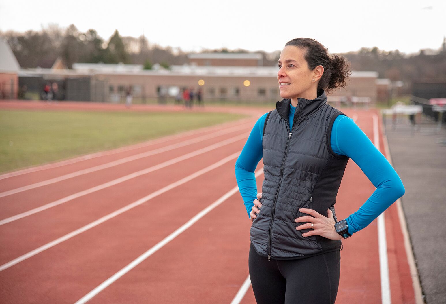 A portrait of a middle-aged woman reflecting at a local track